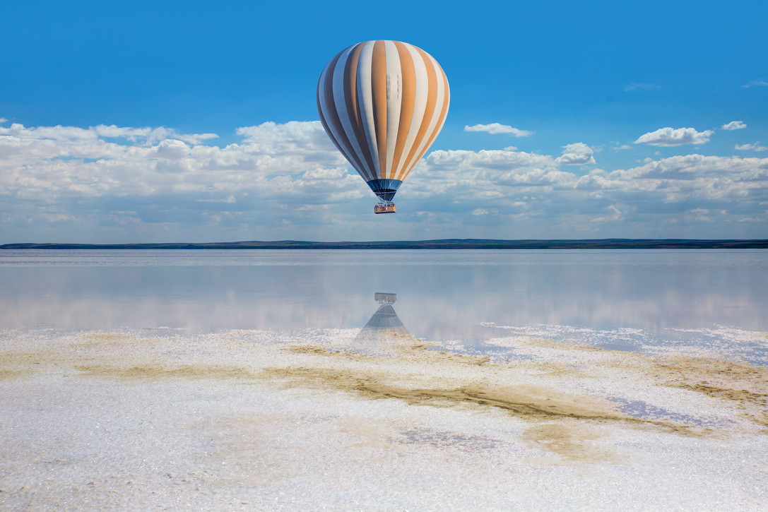 Hot Air Balloon Flying Over Lake